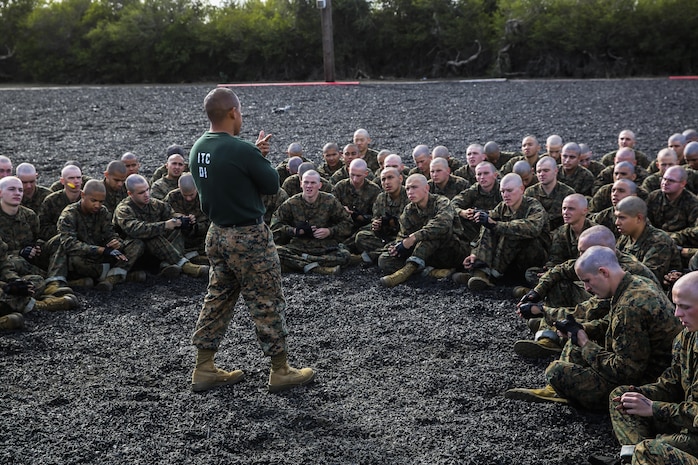 Sergeant Nelson Chavez, martial arts instructor, Instructional Training Company, Support Battalion, speaks to recruits with Bravo Company, 1st Recruit Training Battalion, about real-world events that tie into their MCMAP session at Marine Corps Recruit Depot San Diego, Nov. 25. At the conclusion of the event, instructors tie in real-world scenarios with what the recruits learned in that session. This helps recruits get a better grasp for what they had learned and how it serves a purpose when it is used in a real life situation. Today, all males recruited from west of the Mississippi are trained at MCRD San Diego. The depot is responsible for training more than 16,000 recruits annually. Bravo Company is scheduled to graduate Feb. 12.
