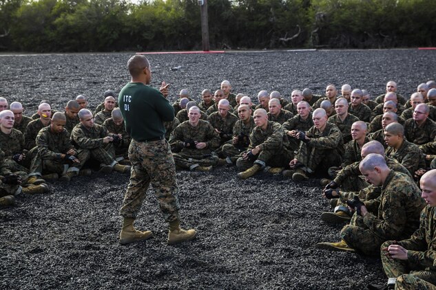 Sergeant Nelson Chavez, martial arts instructor, Instructional Training Company, Support Battalion, speaks to recruits with Bravo Company, 1st Recruit Training Battalion, about real-world events that tie into their MCMAP session at Marine Corps Recruit Depot San Diego, Nov. 25. At the conclusion of the event, instructors tie in real-world scenarios with what the recruits learned in that session. This helps recruits get a better grasp for what they had learned and how it serves a purpose when it is used in a real life situation. Today, all males recruited from west of the Mississippi are trained at MCRD San Diego. The depot is responsible for training more than 16,000 recruits annually. Bravo Company is scheduled to graduate Feb. 12.