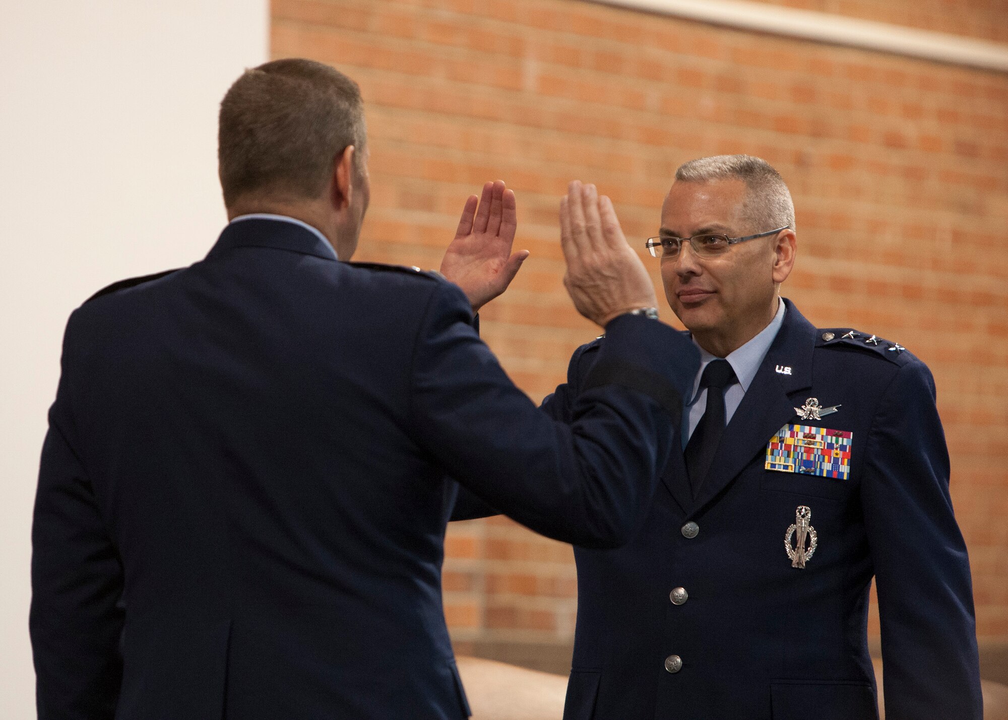 Gen. Robin Rand, Air Force Global Strike Command commander, swears in Lt. Gen. Jack Weinstein to his new rank during his promotion ceremony Nov. 16, 2015, on F.E. Warren Air Force Base, Wyo. Weinstein is the first 3-star to fill the position of deputy chief of staff for strategic deterrence and nuclear integration. Elevating the position to a 3-star is another step toward strengthening leadership focus on the nuclear enterprise. (U.S. Air Force photo by Lan Kim)