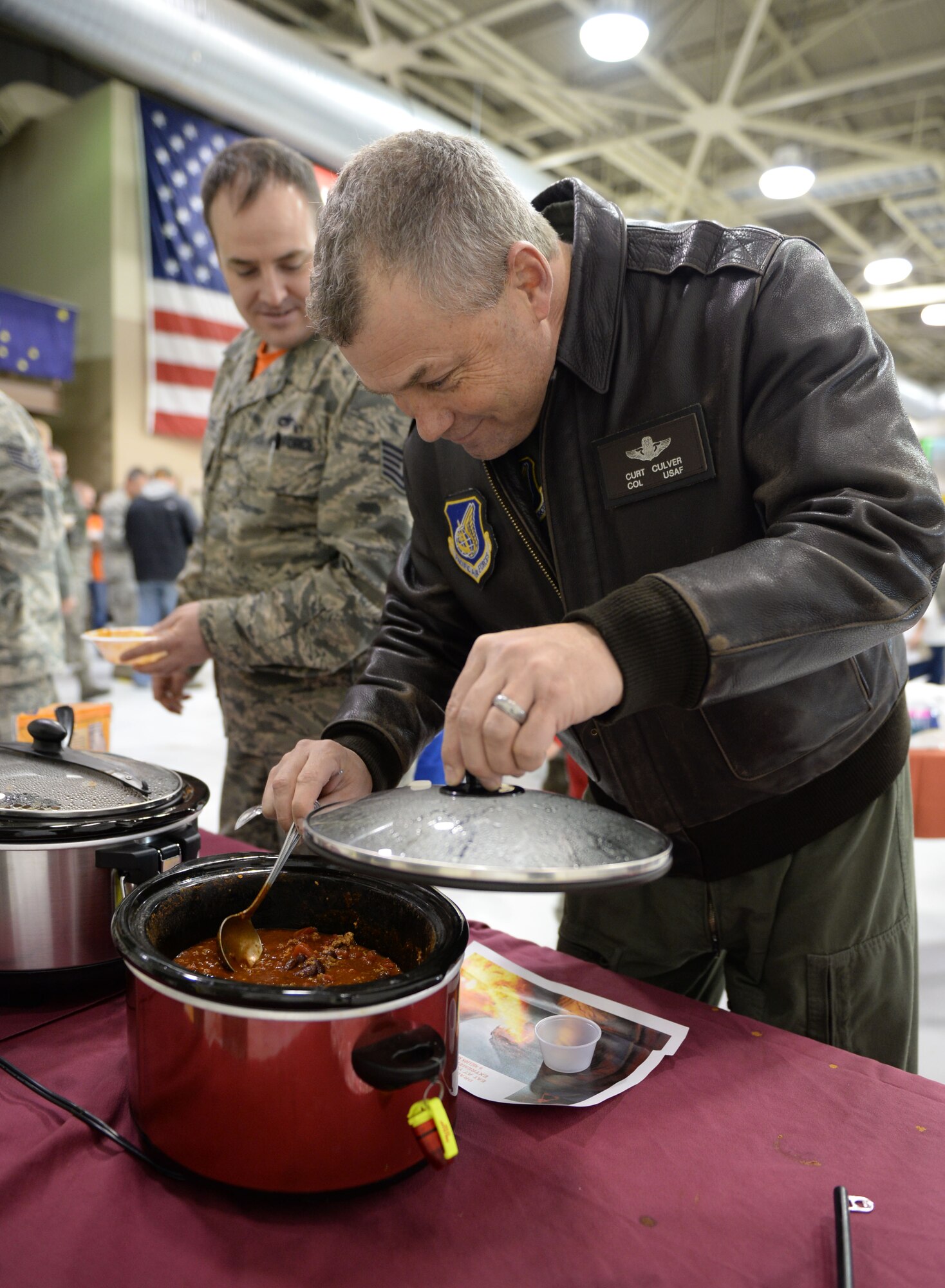 U.S. Air Force Col. William Culver, the 354th Fighter Wing vice commander, dips a spoon into the “dragon’s blood hot” chili during a maintenance group chili cook off at Eielson Air Force Base, Alaska, Nov. 20, 2015. Keeping the annual gathering tradition alive, various groups of the 354th Fighter Wing joined together in celebration of the Thanksgiving holiday. (U.S. Air Force photo by Senior Airman Racheal E. Watson/Released) 