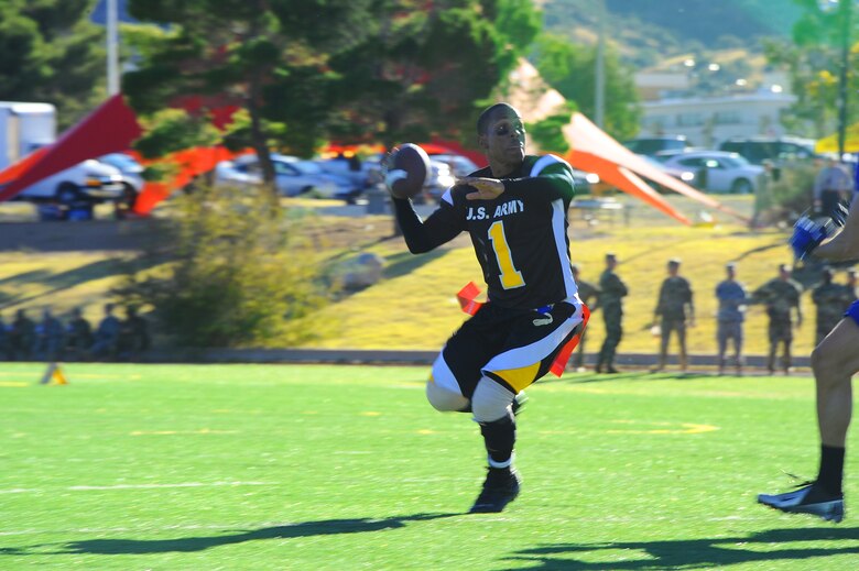 A Fort Huachuca Black Knights quarterback prepares to throw a pass during the Turkey Bowl 2015 at Fort Huachuca, Nov. 20, 2015. The Mustangs defeated the Black Knights 24-6 to secure their second consecutive Turkey Bowl championship. (U.S. Air Force photo by Airman 1st Class Mya M. Crosby/Released)
