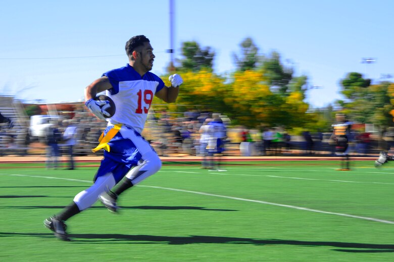 U.S. Air Force Senior Airman Jemal Young, Davis-Monthan Air Force Base Mustangs offensive lineman, runs toward the end zone during the Turkey Bowl 2015, Nov. 20, 2015. The Turkey Bowl 2015 was hosted by Fort Huachuca to promote camaraderie, build esprit de corps, and collect canned good for the community food bank. (U.S. Air Force photo by Airman 1st Class Mya M. Crosby/Released)
