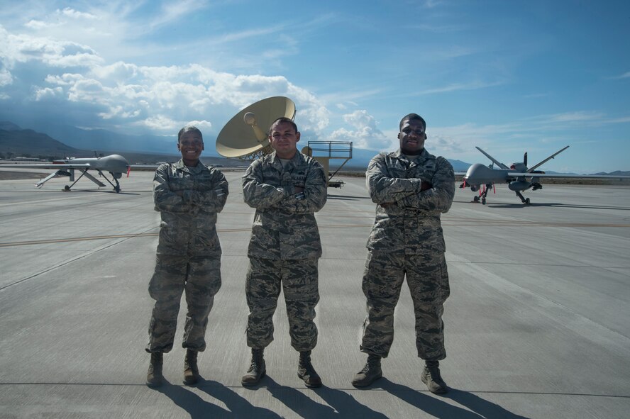 Staff Sgt. Jalesa , 432nd Wing/432nd Air Expeditionary Wing protocol technician,  left, Tech. Sgt. Daniel, 432nd WG/432nd AEW NCO in charge of protocol, center, and Airman 1st Class Raheem, 432nd WG/432nd AEW protocol technician, pose for a group photo Oct. 19, 2015, at Creech Air Force Base, Nevada. The Creech AFB protocol office is one of the smallest in Air Combat Command, but directly oversees approximately 500 visitors annually which range from Air Force leaders to Department of Defense chair holders to foreign dignitaries. They are also responsible for over 60 ceremonies annually to include promotion ceremonies, retirements, award ceremonies, and change of commands. (U.S. Air Force photo by Tech. Sgt. Nadine Barclay/Released)