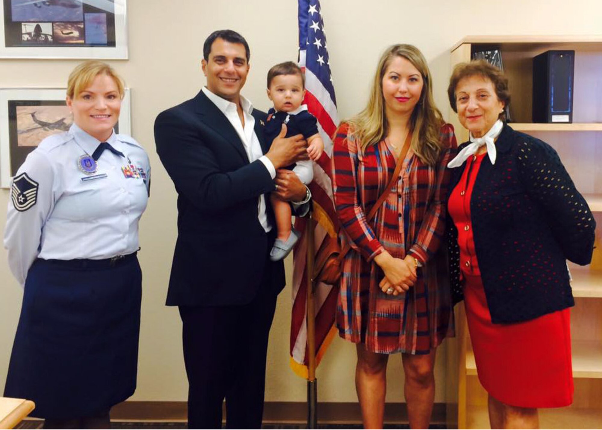 Dr. John Beshai, Arizona Mayo Clinic cardiologist and senior associate consultant, poses with  Master Sgt. Randi Cross, Air Force Reserve Command health professions recruiter, son Rouk, wife Brooke and mother, Ivy Beshai after the Oath of Office ceremony Oct. 24, at Luke Air Force Base, Ariz. (U.S. Air Force photo taken by Chief Master Sgt. Chin Cox)