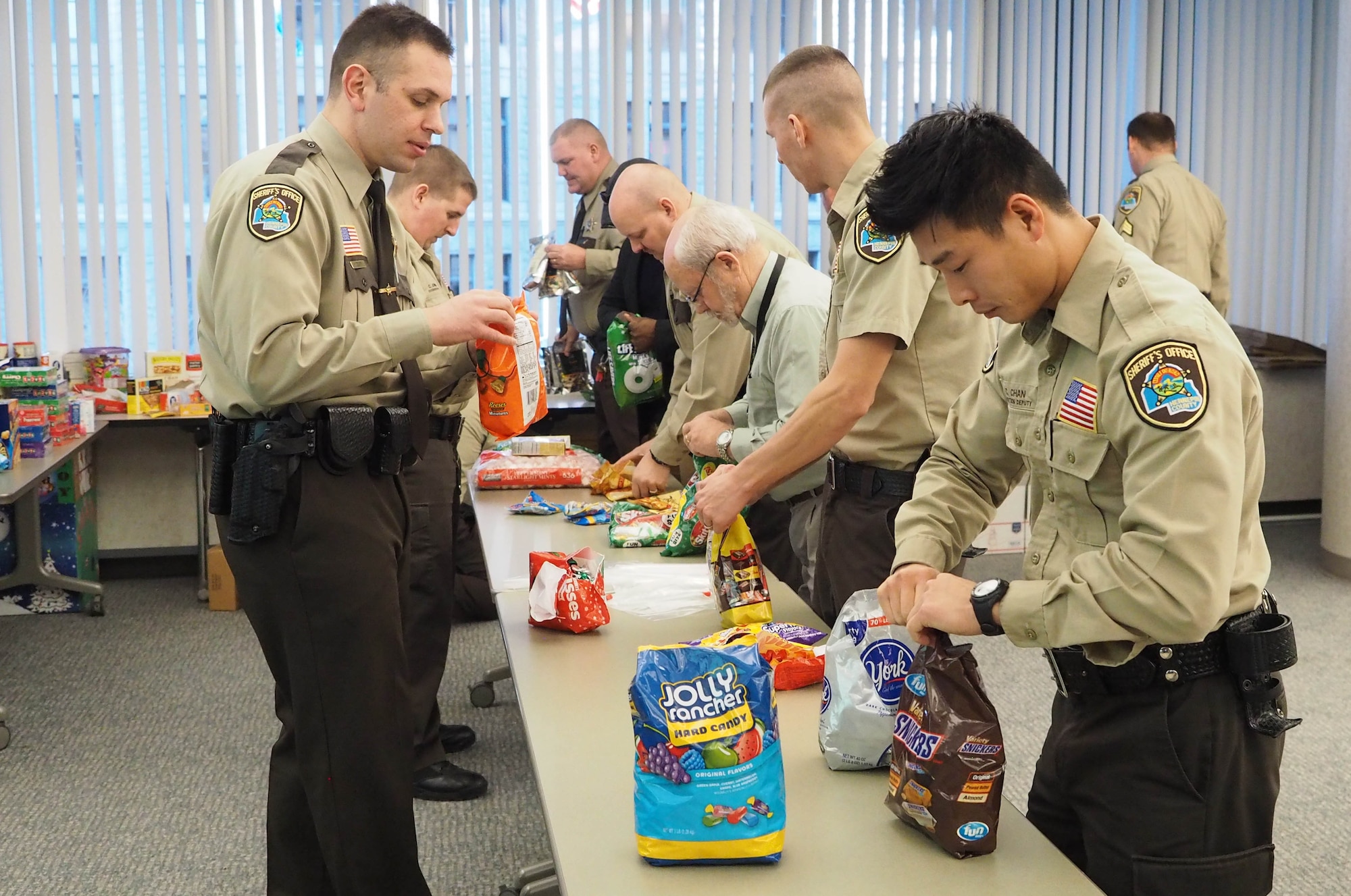 Hennepin County Sheriff deputies pack up holiday items to be shipped to deployed military members. (Air Force Photo/Paul Zadach)