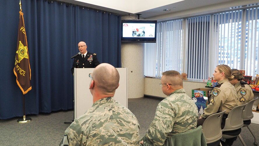 Maj. Gen. Richard C. Nash, Minnesota National Guard adjudant general, talks with Hennepin County Sheriff's Office deputies and military guests during a holiday gathering Nov. 24. (Air Force Photo/Paul Zadach)
