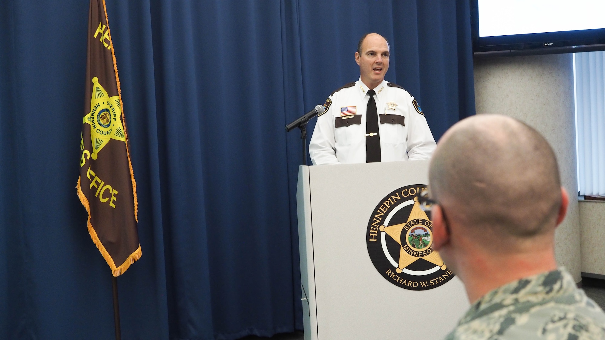 Hennepin County Sheriff Richard W. Stanek talks with HCSO deputies, employees and military guests Nov. 24. (Air Force Photo/Paul Zadach)