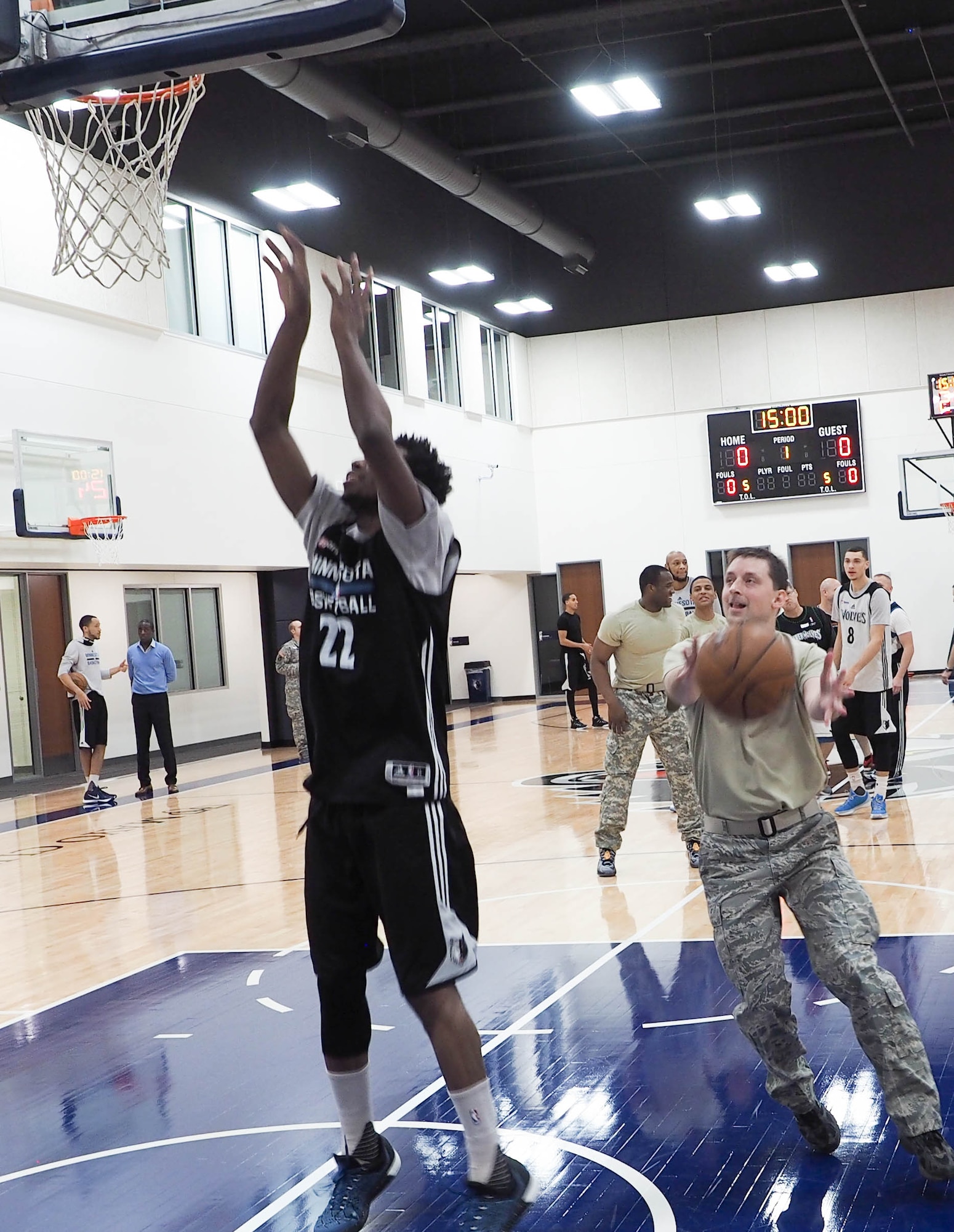 Master Sgt. Cory Copa, 934th Aeromedical Evacucuation Squadron, goes up against Timberwolves Shooting Guard Andrew Wiggins during the Knockout competition. Copa was able to knock Wiggins out of the contest. (Air Force Photo/Paul Zadach)