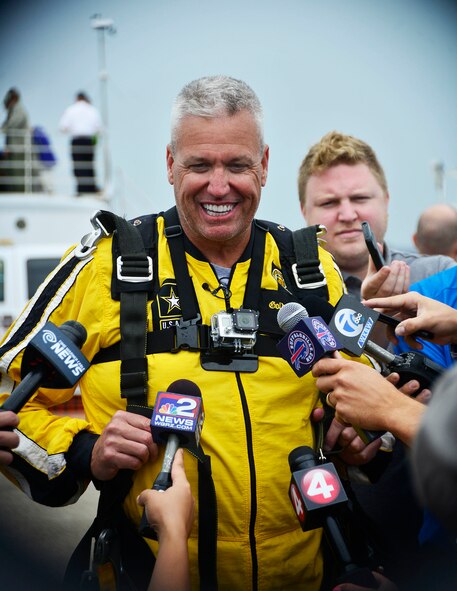 Rex Ryan, head coach of the Buffalo Bill, addresses questions from local media after completing a tandem jump with the U.S. Army Golden Knights during the Thunder of Niagara air show, July 17, 2015, Niagara Falls Air Reserve Station, N.Y. (U.S. Air Force photo by Tech. Sgt. Stephanie Sawyer)
