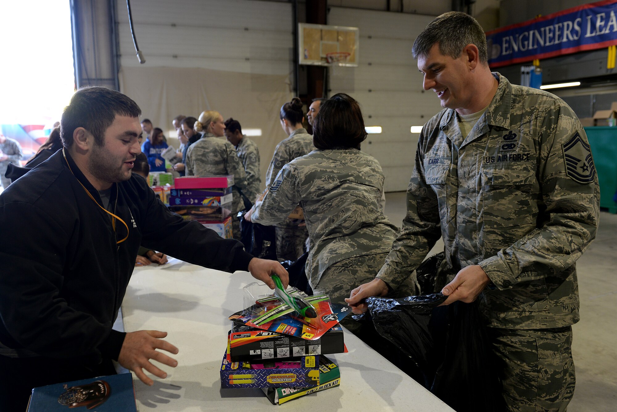 H.E.R.O.E.S. Care volunteers sort and hand out toys to first sergeants Nov. 20, 2015, Scott Air Force Base, Illinois. H.E.R.O.E.S. Care, a charity organization benefiting military families, collaborated with the Scott AFB First Sergeants Council, to donate around 1,700 toys to Scott families. H.E.R.O.E.S. Care exists through community ties that ensure they meet their goal of supporting military families. (U.S. Air Force photo by Airman 1st Class Erica Holbert-Siebert)