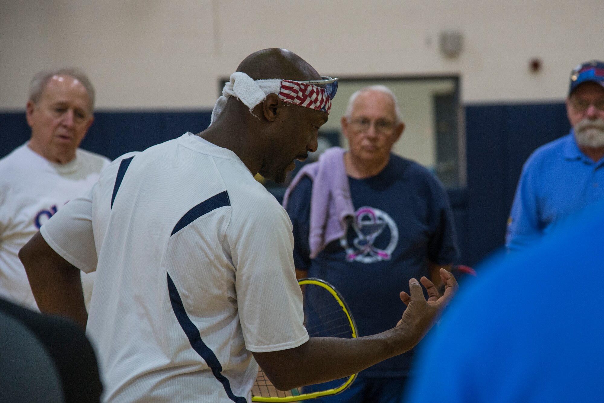 Steven Harper, the executive director of the Military Racquetball Federation, explains racquet ball basics to veterans from the Jefferson Barracks November 13, 2015, at the James Sports Center. MRF is a non-profit organization that goes around and holds clinics for wounded warriors and veterans of all branches. (U.S. Air Force photo by Airman Gwendalyn Smith) 