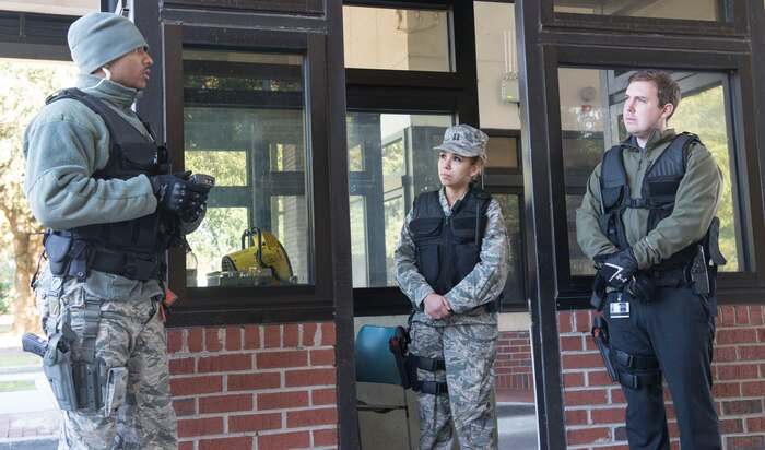 (From left to Right) Airman 1st Class Devin-Christopher Guignard, 628th Security Forces Squadron installation entry controller officer, explains to Capt. Marsha Miranda, 628th Medical Group Family Practice doctor and Ryan Moore, 628th MDG physical therapist, how to man a gate at JB Charleston – AB, S.C., on Nov. 20, 2015. By getting the feel for how Security Forces work at the gates, Moore evaluated how Security Forces members were affected physically. (U.S. Air Force photo/Airman 1st Class Thomas T. Charlton)