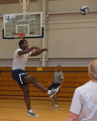 Senior Airman Martin Jackson, 628th Security Forces Squadron defender, hits a ball during a volleyball tournament against chief master sergeants and first sergeants from the installation at Joint Base Charleston – Air Base, S.C., on Nov. 23, 2015. The volleyball tournament was held as a teambuilding and communication exercise for Airman Leadership School students preparing to become non-commissioned officers. (U.S. Air Force photo/Airman 1st Class Thomas T. Charlton)