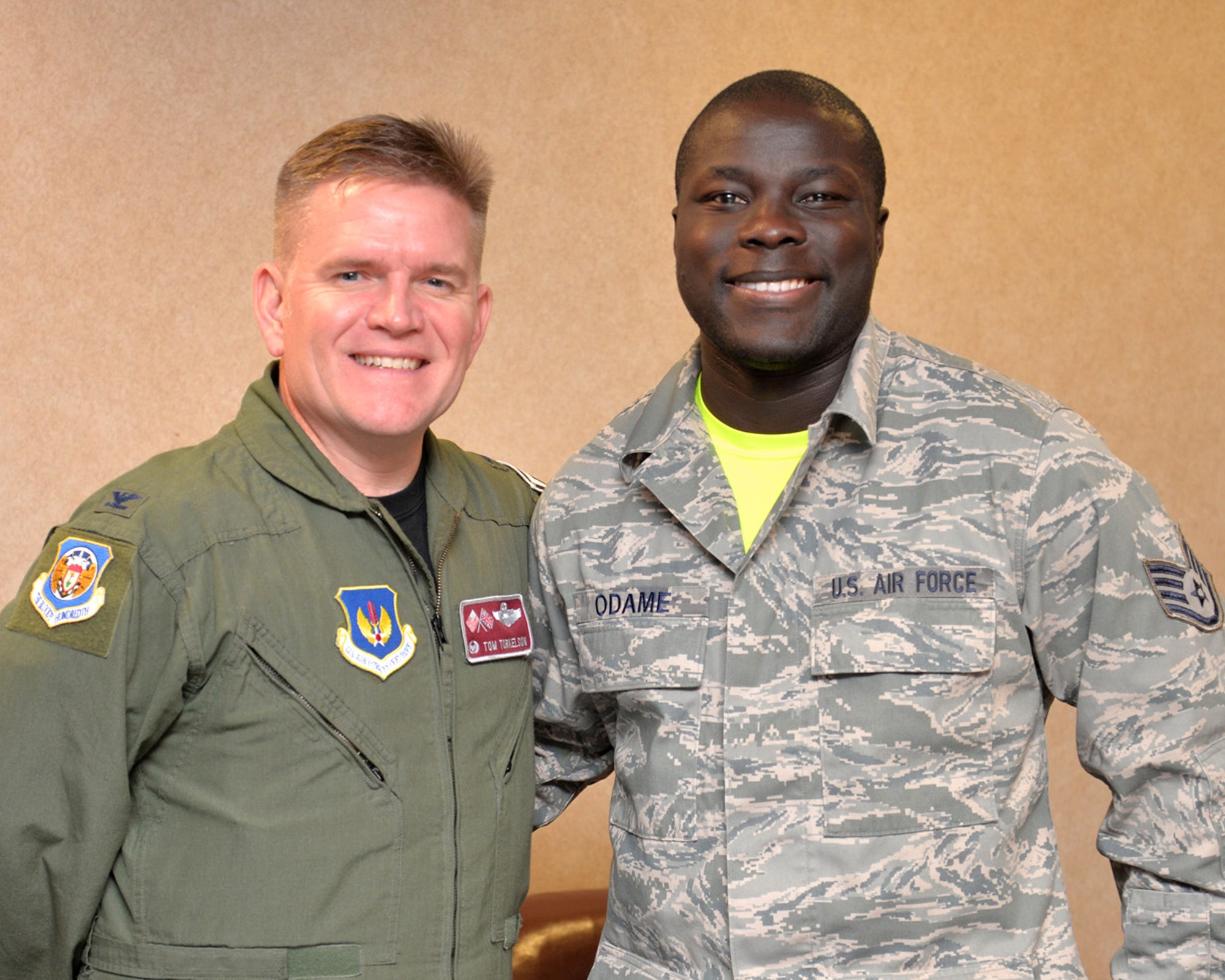 U.S. Air Force Staff Sgt. Richard Odame, right, 727th Air Mobility Squadron air freight supervisor, stands with U.S. Air Force Col. Thomas D. Torkleson, 100th Air Refueling Wing commander, after being presented a Commander’s Coin, Nov. 13, 2015, on RAF Mildenhall. Odame helped a cyclist who had been hit by a motorist, Nov. 2, 2015, along the A1101 near Mildenhall, England. Odame ensured the cyclist was kept conscious and warm while directing traffic until the local emergency services arrived. (U.S. Air Force photo by Karen Abeyasekere/Released)