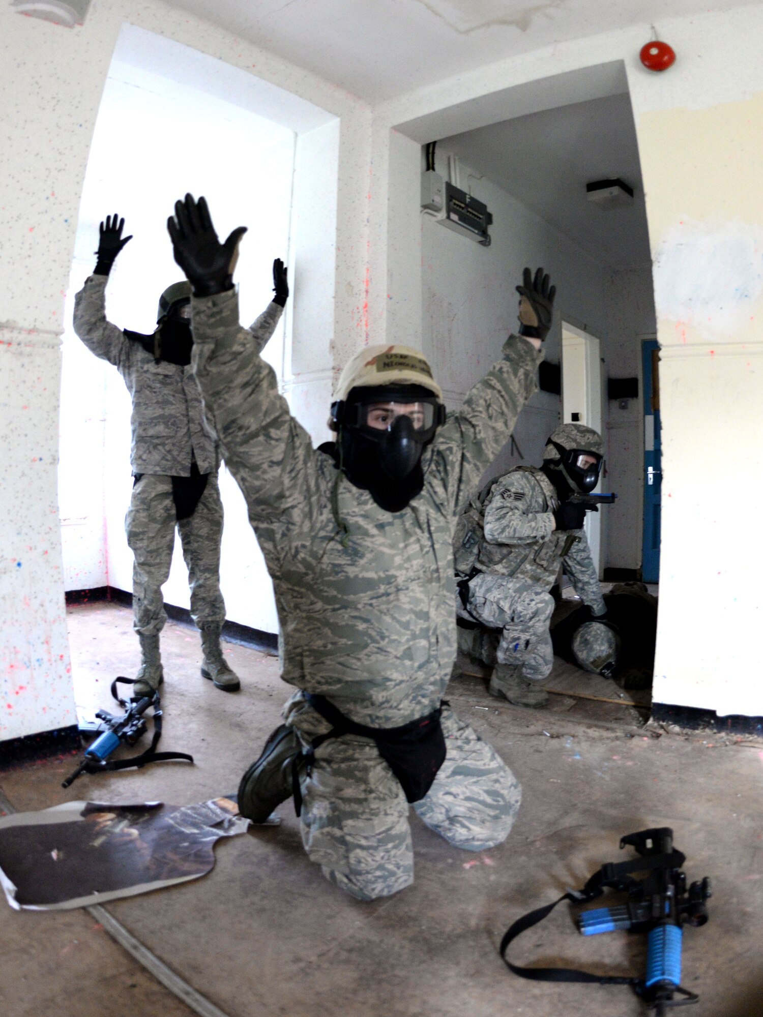 U.S. Air Force Airmen properly surrender to proper authorities during expeditionary active shooter training Nov. 23, 2015, on RAF Feltwell, England. The new training, implemented Oct. 1, is designed to prepare deploying Airmen for an environment where firearms are potentially more prevalent, meaning they might be armed and have to protect themselves and others from the threat of an active shooter. (U.S. Air Force photo by Senior Airman Kate Thornton/Released)