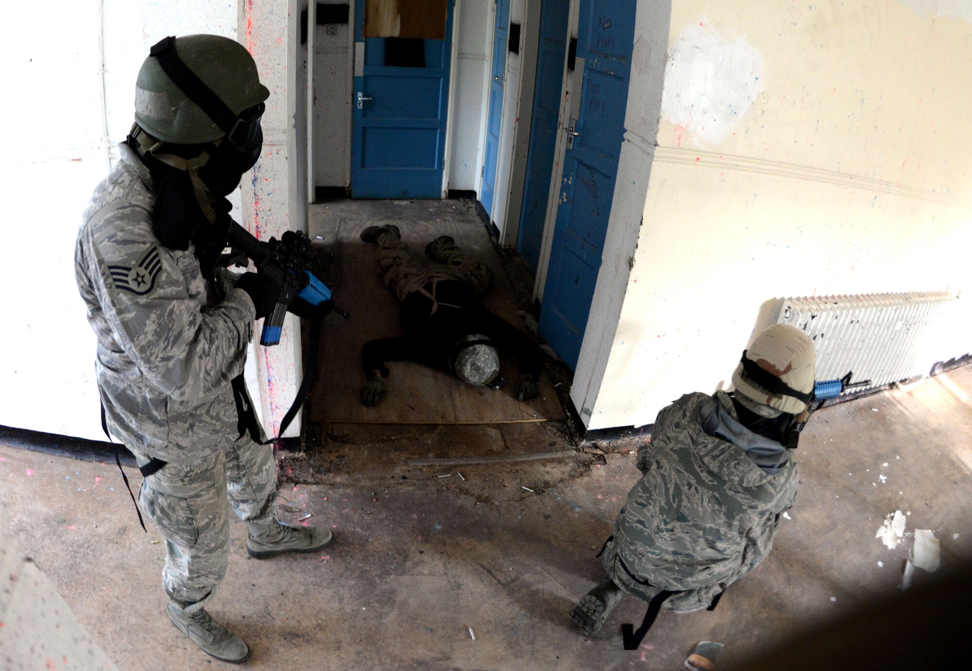 U.S. Air Force Staff Sgt. Shannon Smith, left, 100th Maintenance Group maintenance analyst, and U.S. Air Force Airman 1st Class Nicholas Vidmar, 100th Aircraft Maintenance Squadron crew chief, practice the “fight” response to an active shooter during expeditionary active shooter training Nov. 23, 2015, on RAF Feltwell, England. The new training, implemented Oct. 1, is designed to prepare deploying Airmen for an environment where firearms are potentially more prevalent, meaning they might be armed and have to protect themselves and others from the threat of an active shooter. (U.S. Air Force photo by Senior Airman Kate Thornton/Released)
