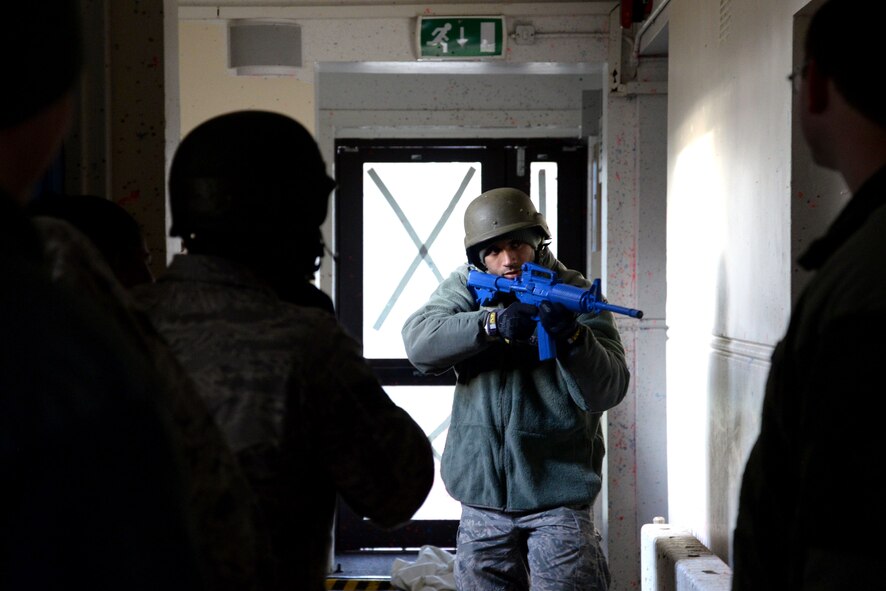 U.S. Air Force Senior Airman Scott Nelson, center, 100th Aircraft Maintenance Squadron electro-environmental technician, practices room-clearing techniques during expeditionary active shooter training Nov. 23, 2015, on RAF Feltwell, England. As Airmen first enter the shoot-house during training, they’re taught a series of tactical movements useful during an active shooter threat. (U.S. Air Force photo by Senior Airman Kate Thornton/Released)