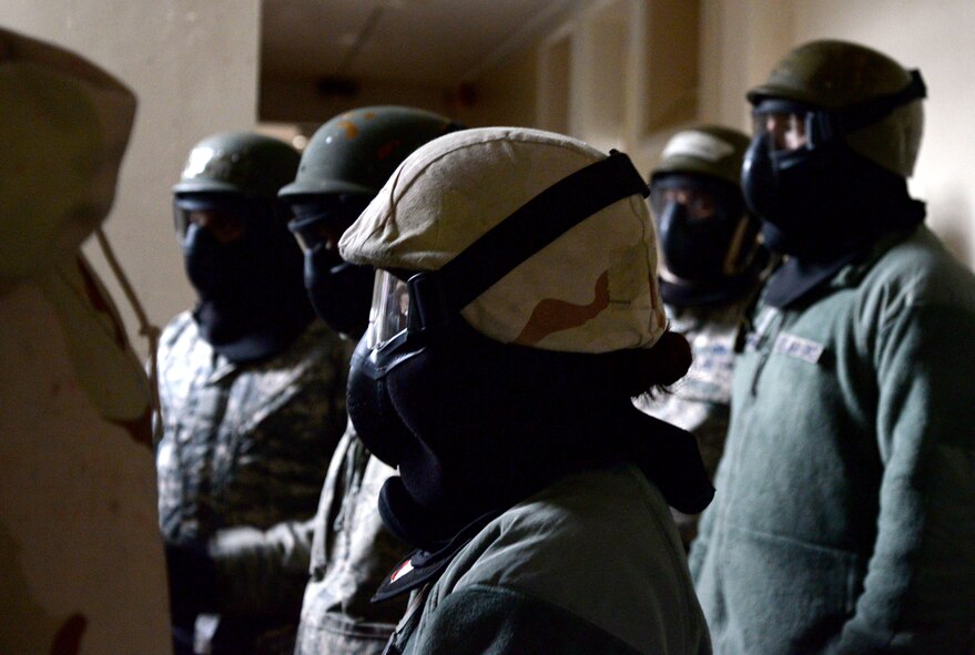 U.S. Air Force Airmen listen to instructions during expeditionary active shooter training Nov. 23, 2015, on RAF Feltwell, England. As Airmen first enter the shoot-house during training, they’re taught a series of tactical movements useful during an active shooter threat. (U.S. Air Force photo by Senior Airman Kate Thornton/Released)