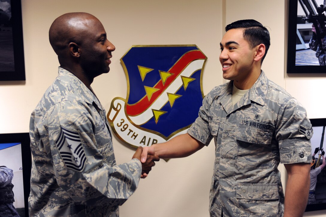 Chief Master Sgt. Vegas Clark, 39th Air Base Wing command chief, greets Airman 1st Class Raul Reyna, 39th Medical Support Squadron medical logistician, before beginning his chief shadow day Nov. 20, 2015. Airmen are chosen for the command chief’s shadow program based on their commander’s recommendation and their dedication to the mission and their job. (U.S. Air Force photo by Airman 1st Class Daniel Lile/Released)