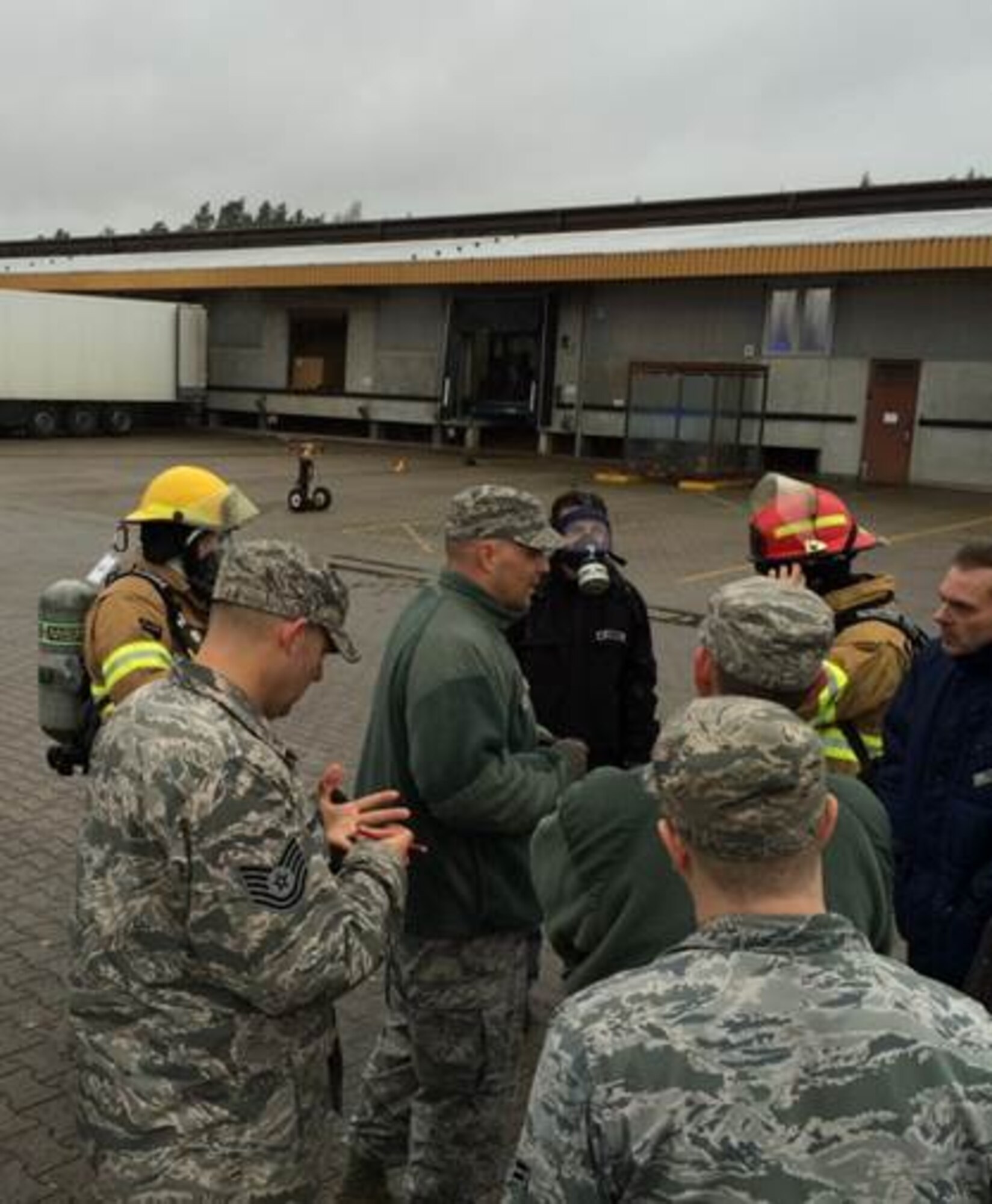 Firefighters from the 86th Civil Engineering Squadron assess the situation during a chemical line rupture at the cold storage facility Nov. 17, 2015, at Ramstein Air Base, Germany. The Airmen coordinated with several other Kaiserslautern Military Community firefighters and bio-environmental Airmen to suppress and contain a chemical  leakage that threated to spoil  millions of dollars in meat inventory. (Courtesy photo)