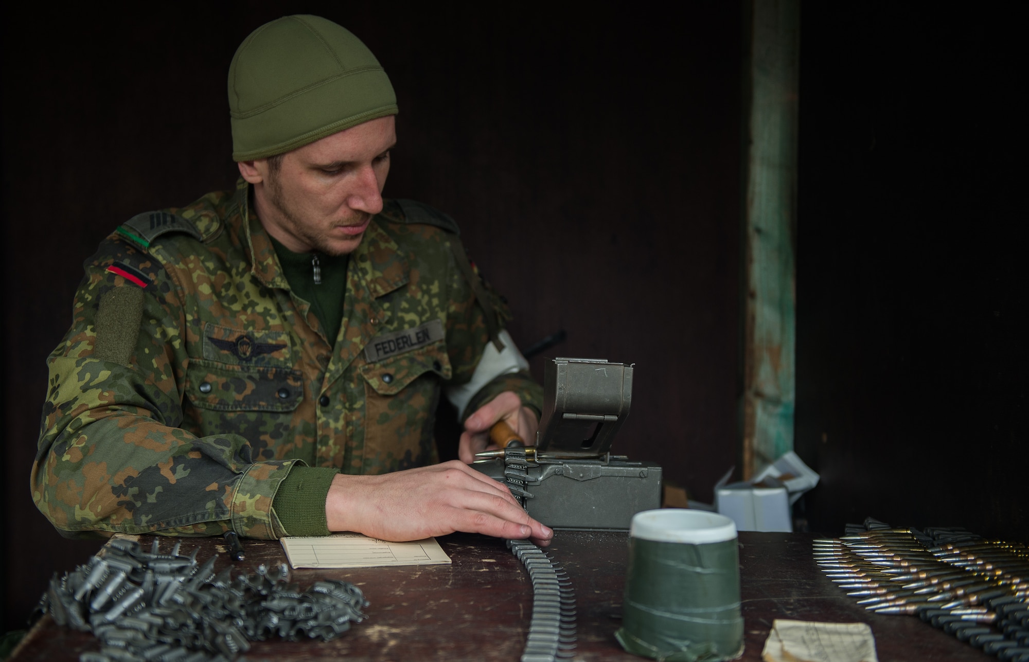 German Army Spc. Deniver Federlein, Airborne Infantry Regiment 26, 4th Company Airborne Troop, reloads ammunition for an MG3 machine gun Nov. 18, 2015, at Zweibruecken, Germany. German Soldiers hosted members of the 86th Security Forces Squadron as they attempted to earn the Bundeswehr (German army) marksmanship badge. (U.S. Air Force photo/Senior Airman Damon Kasberg)