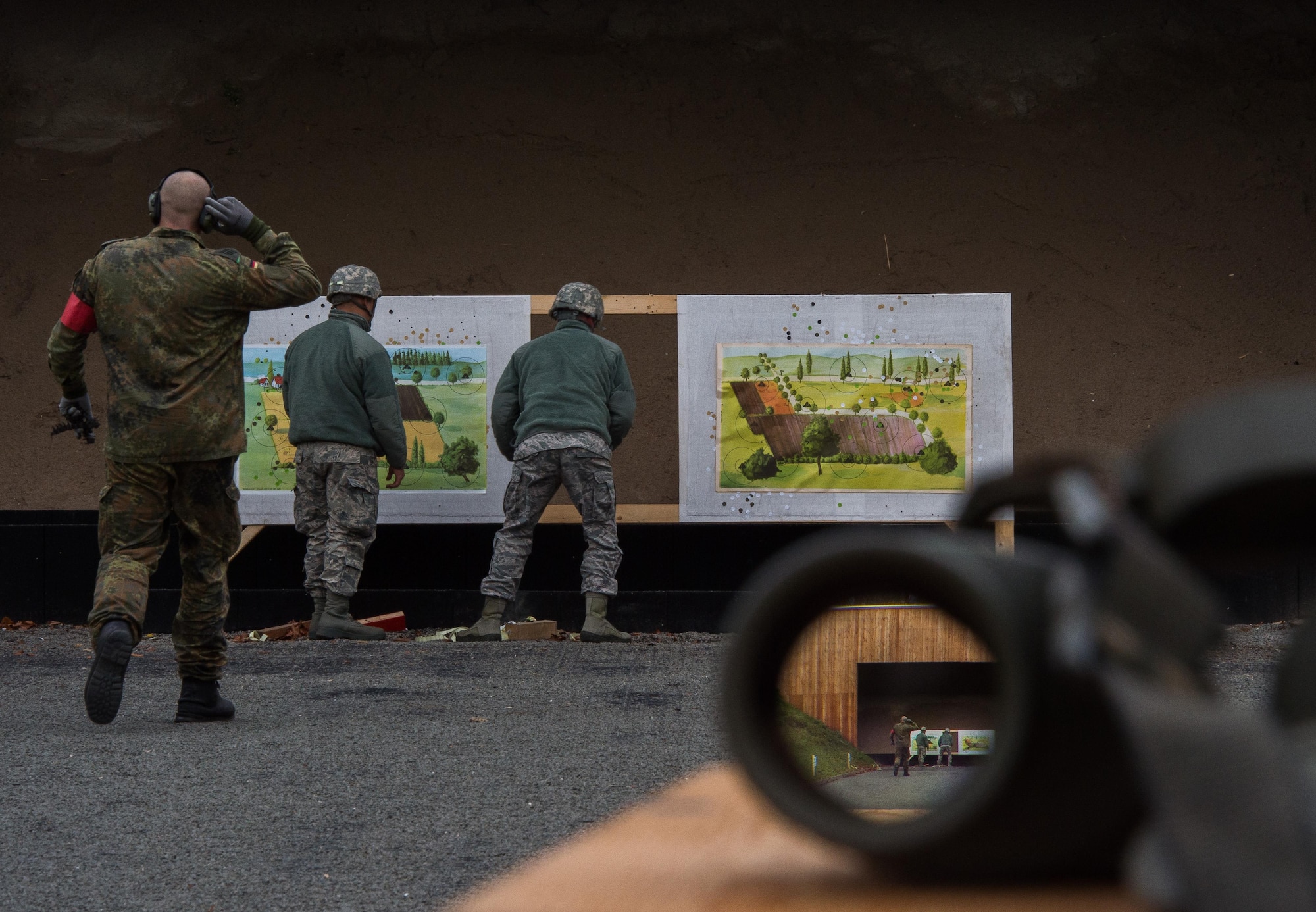 Members of the 86th Security Forces Squadron adjust targets in preparation for the next round of shooting Nov. 18, 2015, at Zweibruecken, Germany. Members of the 86th SFS shot the P8 pistol, G36 assault rifle and MG3 machine gun to earn the Bundeswehr (German army) marksmanship badge for weapons proficiency. (U.S. Air Force photo/Senior Airman Damon Kasberg)