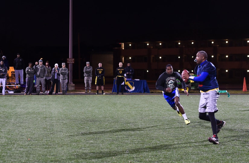 Craig Crews, AFDW Analysis, Assessments, and Lessons Learned division chief, intercepts a football during the Intramural Football Championship game. The 79th Medical Group came from the losing bracket and won the 2015 Intramural Football Championship. (U.S. Air Force photo by Senior Airman Mariah Haddenham/released)