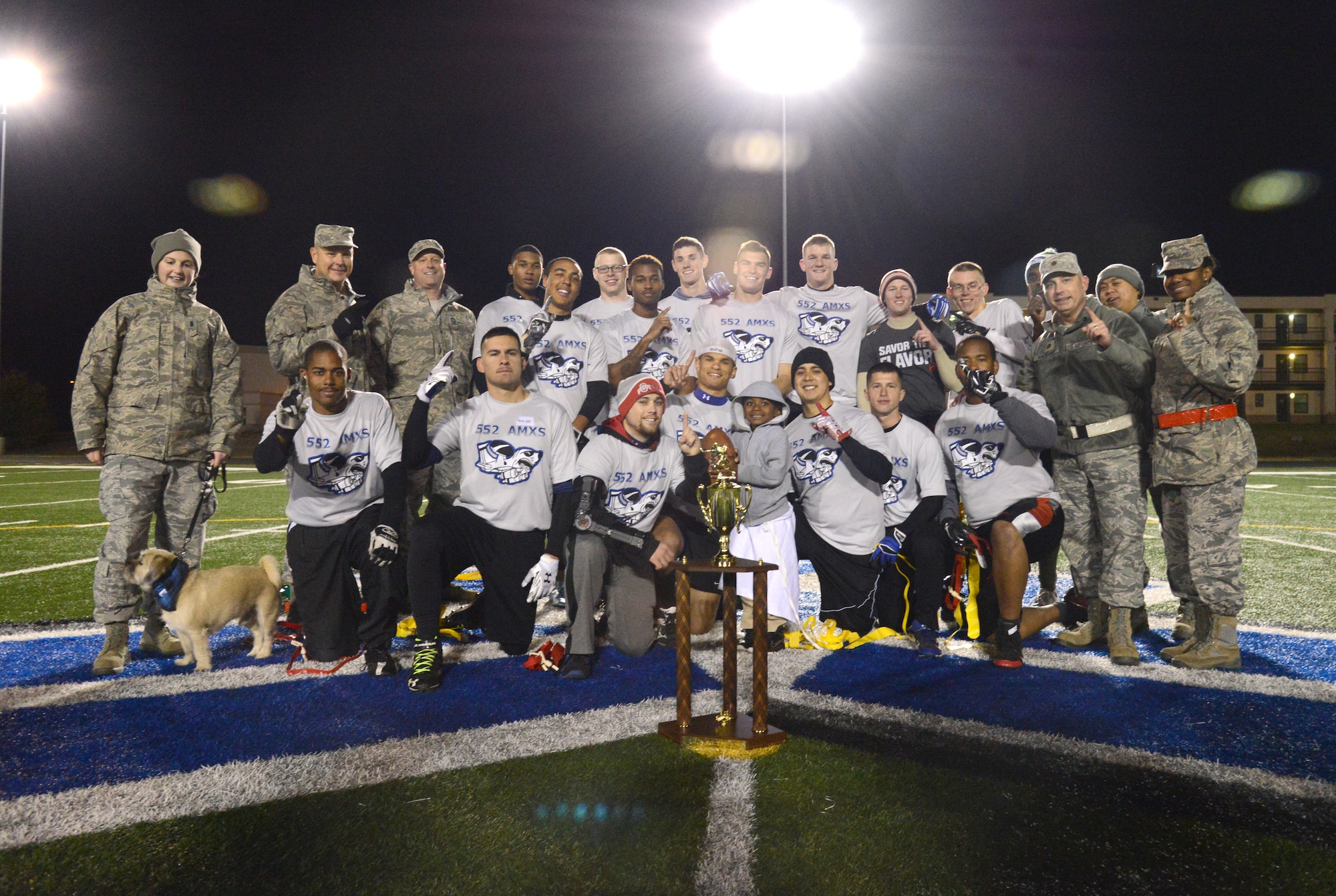 Members and squadron leadership of the 552nd AMXS intramural flag football team celebrate their Nov. 19 fall championship win against Reserve Gold. After their only loss of the season in the first championship game, 552nd AMXS came back and won the second game 27-0. (Air Force photo by Kelly White/Released)