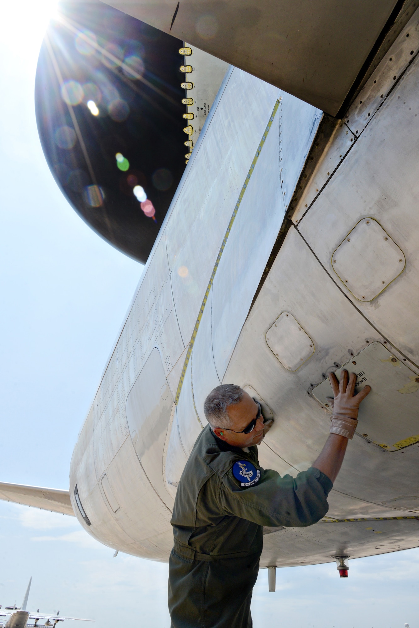 Senior Master Sgt. Tim Brown, an E-3 flight engineer with the 10th Flight Test Squadron, checks the general condition of the AWACS, inside and out, before flights. (Air Force photo by Kelly White/Released)