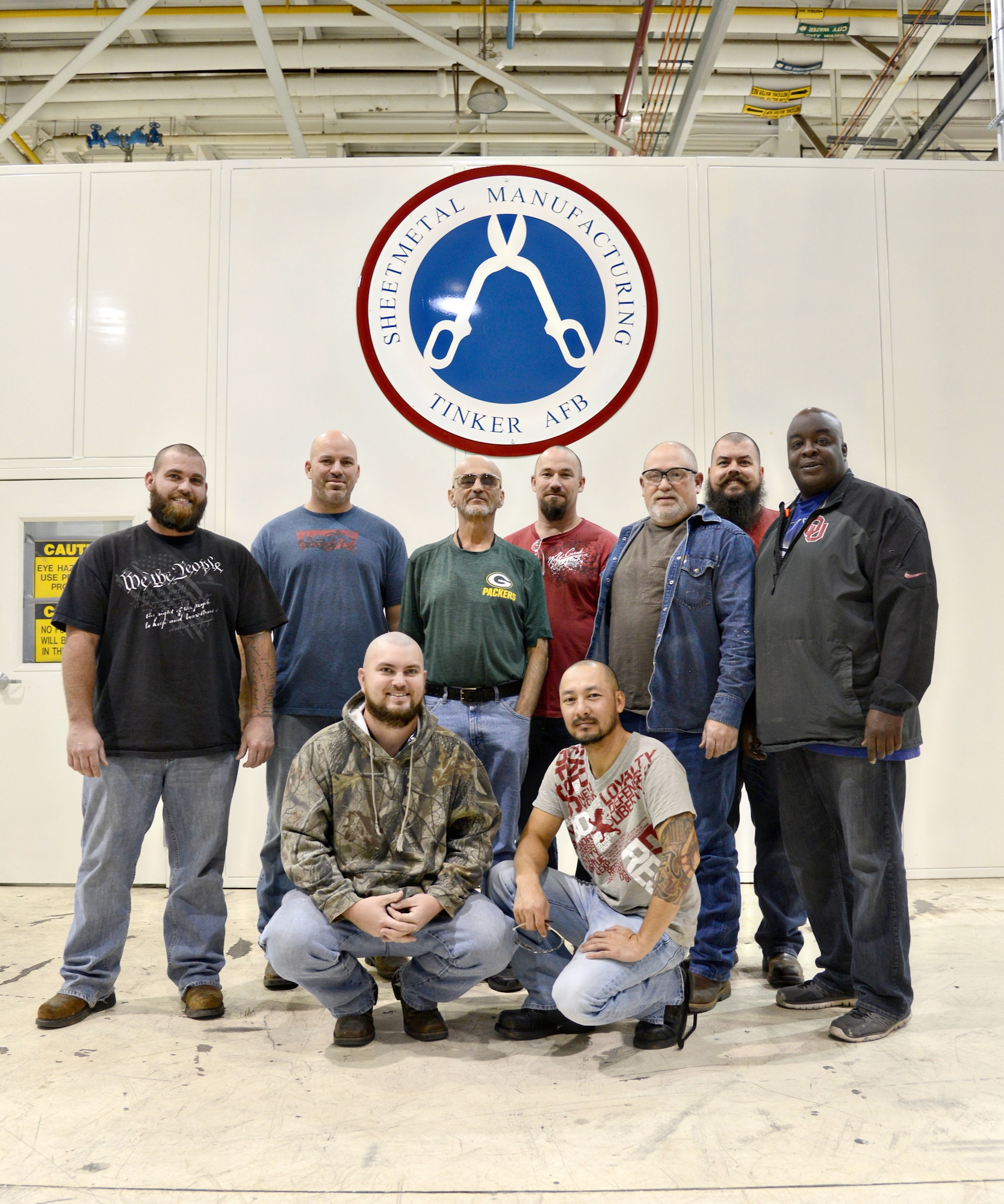 Co-workers in the 551st Commodities Maintenance Squadron showed their support of a colleague and friend by shaving their heads when they found out he had cancer and had to go through chemotherapy. Pictured are, back row, from left, Billy Wiens, Scott Allen, Ralph Odonnell, Paul Sechrist, Eddy Roundtree, Jason Kramer and Alonzo Harris. Front, from left, are Joshua Alexander and Klein Nguyen. Not pictured is their other co-worker LaDean Allen. (Air Force photo by Kelly White/Released)