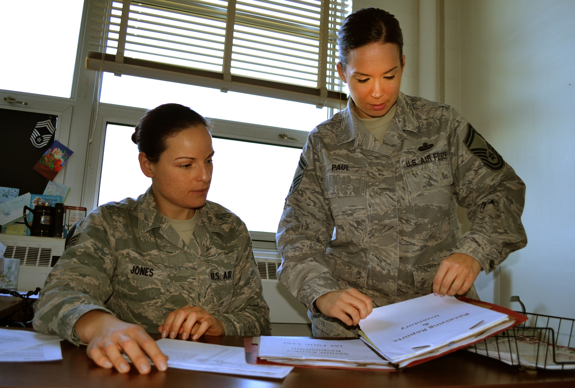 Senior Airman Melissa Jones and Senior Master Sgt. Lauren Paul, both from the 111th Attack Wing Services Flight, review the food order log, Nov. 24, 2015 at Horsham Air Guard Station, Pennsylvania. The services flight is composed of less than 30 members, yet it is responsible for more than 800 Air National Guardsmen, as well as the Army Reserve and Army National Guard during a unit training assembly here. (U.S. Air National Guard photo by Tech. Sgt. Andria Allmond/Released)