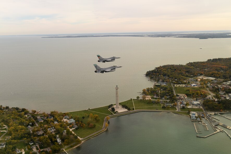 F-16 Fighting Falcons from the 180th Fighter Wing, Ohio Air National Guard, conduct a routine training mission over Perry's Victory and International Peace Memorial in Put-In-Bay, Ohio, Oct. 24, 2015. The 180th FW performs daily training, conducted in realistic environments under realistic circumstances, to ensure our forces maintain the highest levels of proficiency and readiness to defend our nation as the most lethal, innovative and efficient Fighter Wing in the Total Force, both at home and abroad.