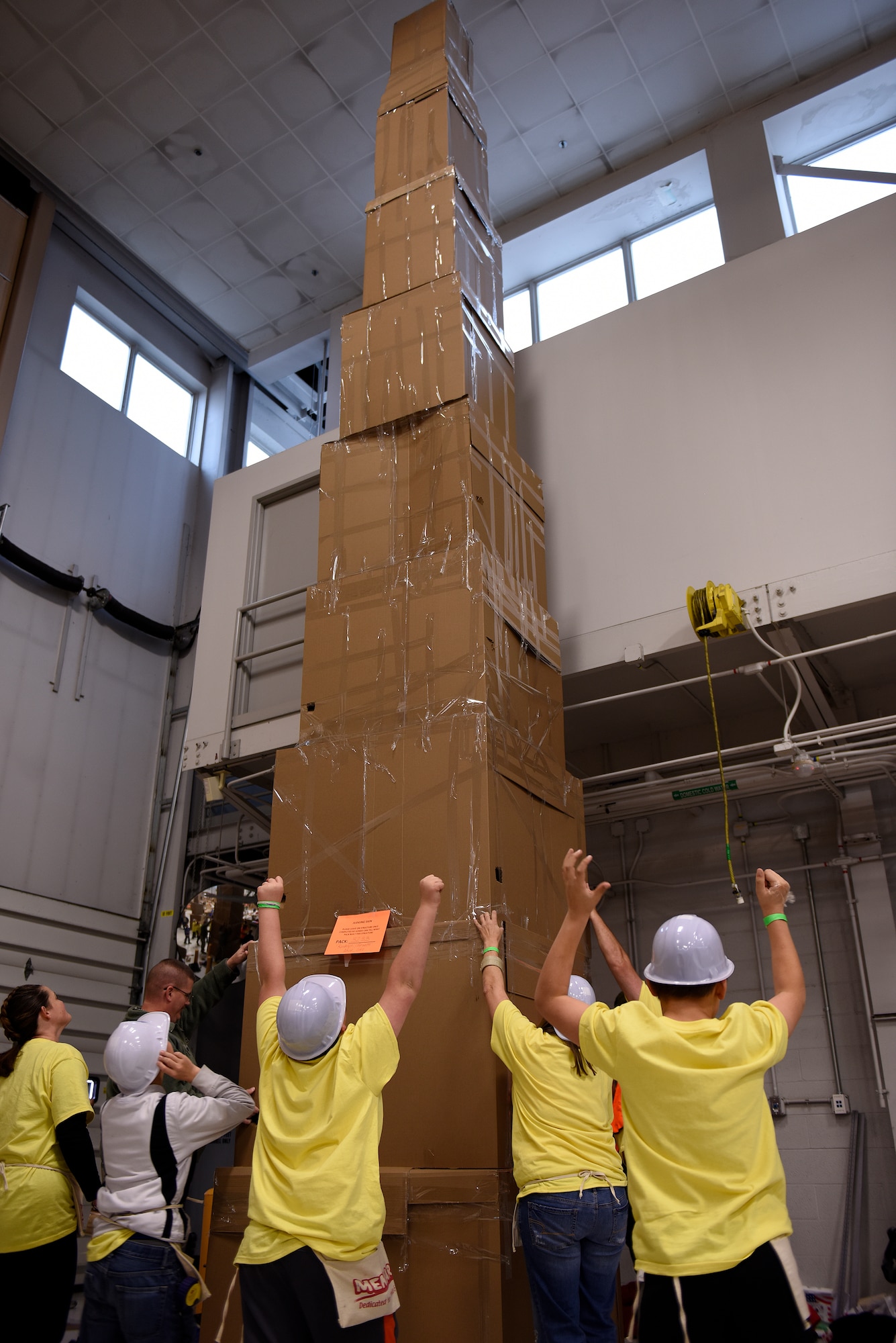 Cub Scouts from Pack 3233 celebrate after completing a 30-foot tall replica of the Washington Monument during Construction City at the 180th Fighter Wing, Sat. Nov. 21, 2015. The 180th FW partnered with the Boy Scouts of America’s Erie Shores Council to host the annual event for more than 450 scouts, parents and volunteers, who took over the hangar during the one-day event to build cities and bridges entirely out of cardboard. (U.S. Air National Guard photo by Staff Sgt. Shane Hughes/Released)