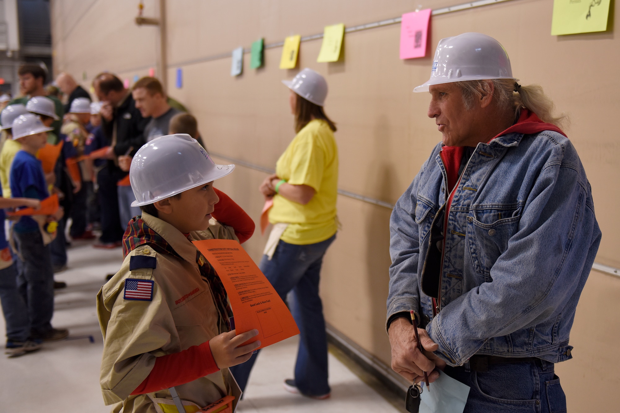 Sam Bencher, a Cub Scout from Pack 1722 seeks an electrical permit from Roy Miller, an adult volunteer, during Construction City at the 180th Fighter Wing, Sat. Nov. 21, 2015. Scouts were required to get 10 different permits before they could begin building. (U.S. Air National Guard photo by Staff Sgt. Shane Hughes/Released)
