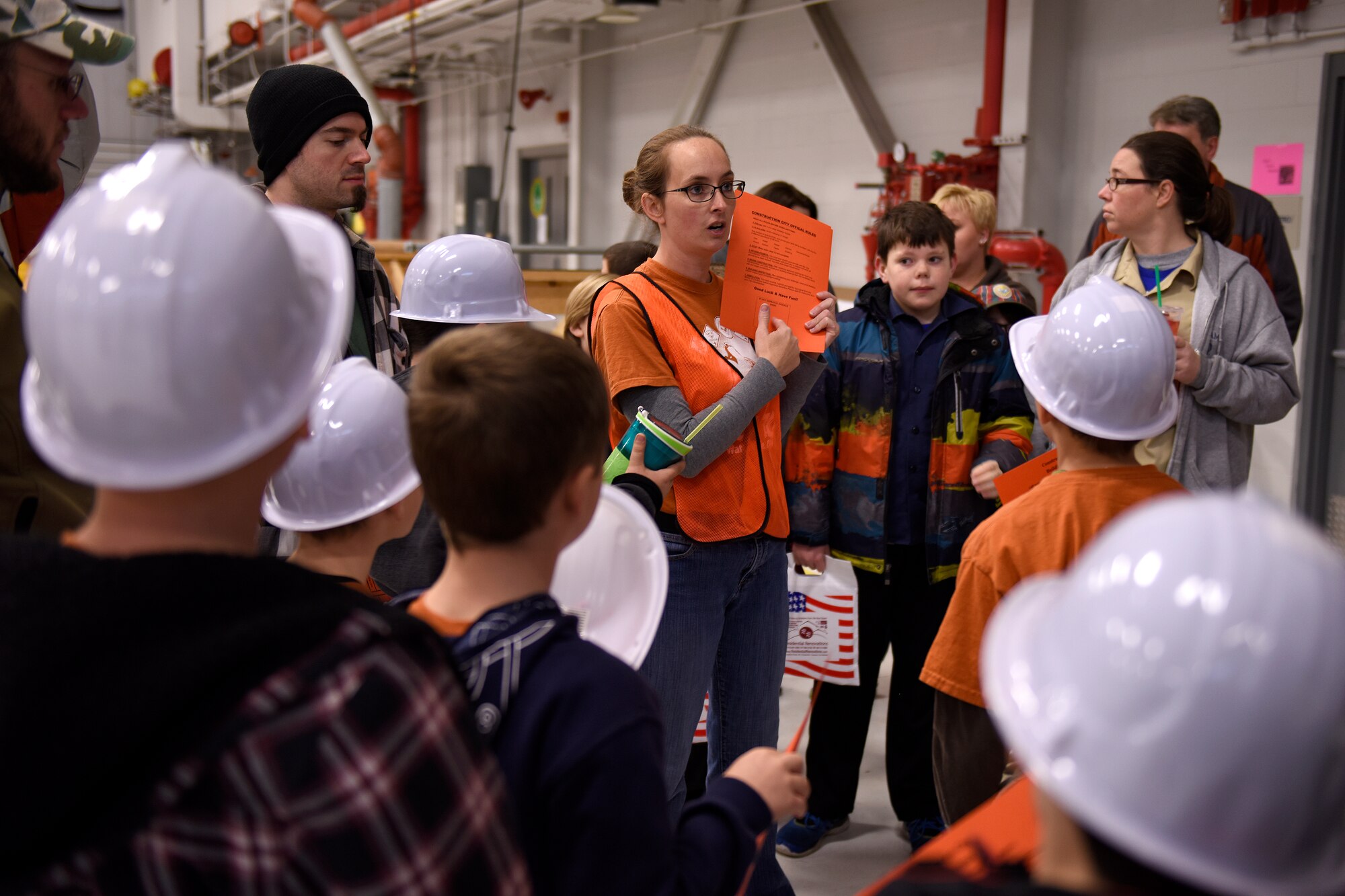 Jennifer Faguett, a volunteer playing the role of a city administrator, explains the permit process to a group of Cub Scouts during Construction City at the 180th Fighter Wing, Sat. Nov. 21, 2015. Throughout the event, scouts learned about the construction process from acquiring proper permits, zoning, design, construction and demolition. (U.S. Air National Guard photo by Staff Sgt. Shane Hughes/Released)
