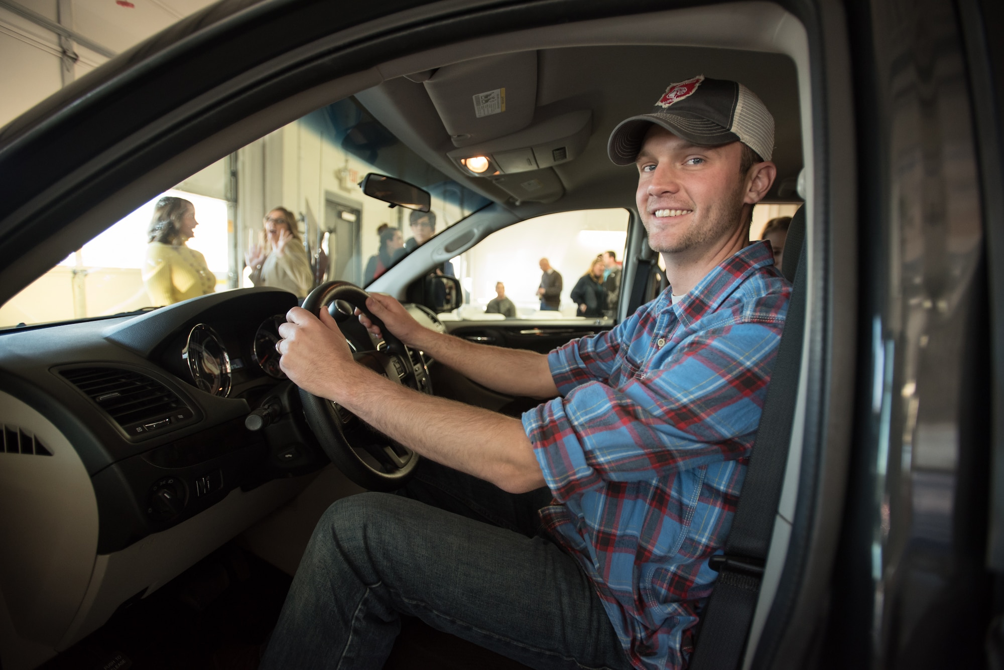 Staff Sgt. Neil Goodlin, a fire team member in the Kentucky Air National Guard’s 123rd Security Forces Squadron, sits behind the wheel of his family’s new minivan during an unveiling ceremony at Oxmoor Collision Center in Louisville, Ky., Nov. 20, 2015. The van was donated to Goodlin as part of the National Auto Body Council’s “Recycled Rides” program, which restores wrecked vehicles to like-new condition before giving them to needy individuals. (U.S. Air National Guard photo by Maj. Dale Greer)