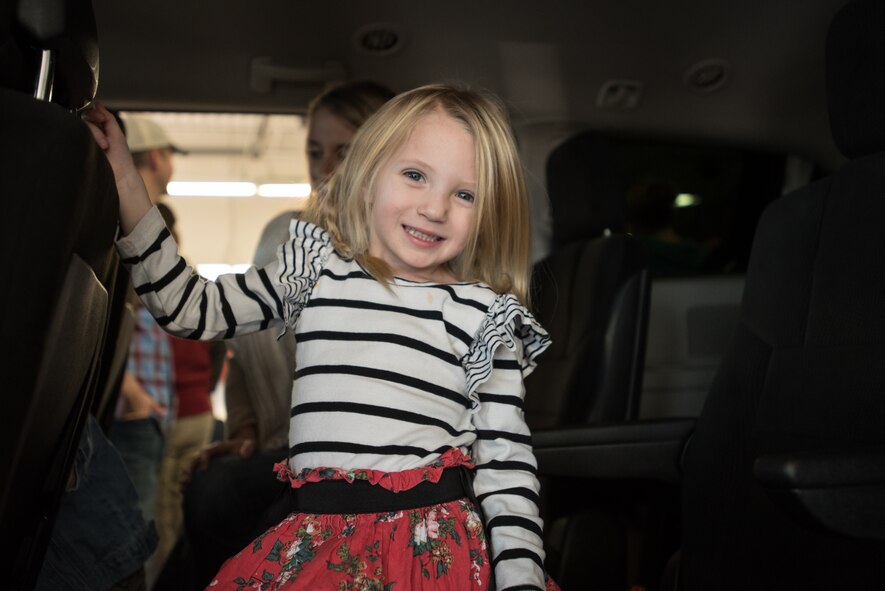 Ava Goodlin, the 3-year-old daughter of Staff Sgt. Neil Goodlin, checks out her family’s new minivan during an unveiling ceremony at Oxmoor Collision Center in Louisville, Ky., Nov. 20, 2015. The van was donated to Neil Goodlin, a fire team member in the Kentucky Air National Guard’s 123rd Security Forces Squadron, as part of the National Auto Body Council’s “Recycled Rides” program, which restores wrecked vehicles to like-new condition before giving them to needy individuals. (U.S. Air National Guard photo by Maj. Dale Greer)