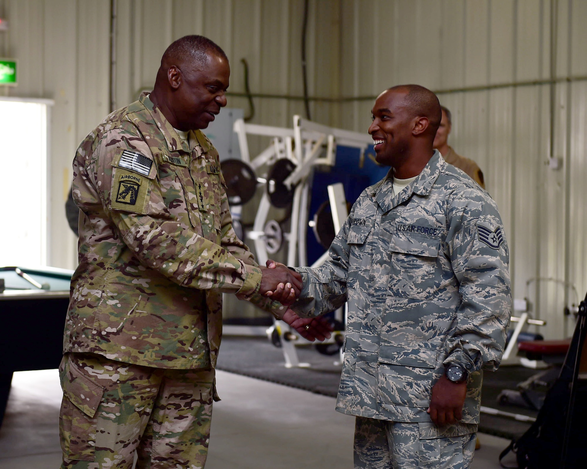 U.S. Army Gen. Lloyd J. Austin III, commander, U.S. Central Command, coins Staff Sgt. Zachary Brown, a 386th Expeditionary Communications Squadron Client Systems Technician, during a visit to the 386th AEW Nov. 24, 2015, at an undisclosed location in Southwest Asia. During his visit Austin presented a coin to four Airmen in recognition for their outstanding performance within their units. (U.S. Air Force photo by Staff Sgt. Jerilyn Quintanilla) 