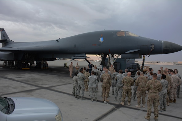 Forty service members participate in a tour of the B-1 Lancer at Al Udeid Air Base, Qatar Nov. 24. The tour featured a presentation on the B-1's capabilities and videos showcasing strikes the bomber has carried out. Service members were selected for the tour by their unit leadership for outstanding performance. (U.S. Air Force photo by Tech. Sgt. James Hodgman/Released)
