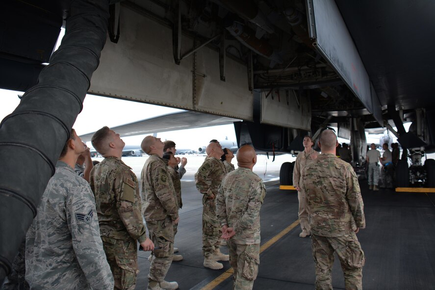1st Lt. Courtney Schantz, 37th Expeditionary Bomb Squadron weapons systems officer, leads 40 service members on a tour of the B-1 Lancer at Al Udeid Air Base, Qatar Nov. 24. The tour featured a presentation on the B-1's capabilities and videos showcasing strikes the bomber has carried out. Service members were selected for the tour by their unit leadership for outstanding performance. (U.S. Air Force photo by Tech. Sgt. James Hodgman/Released)