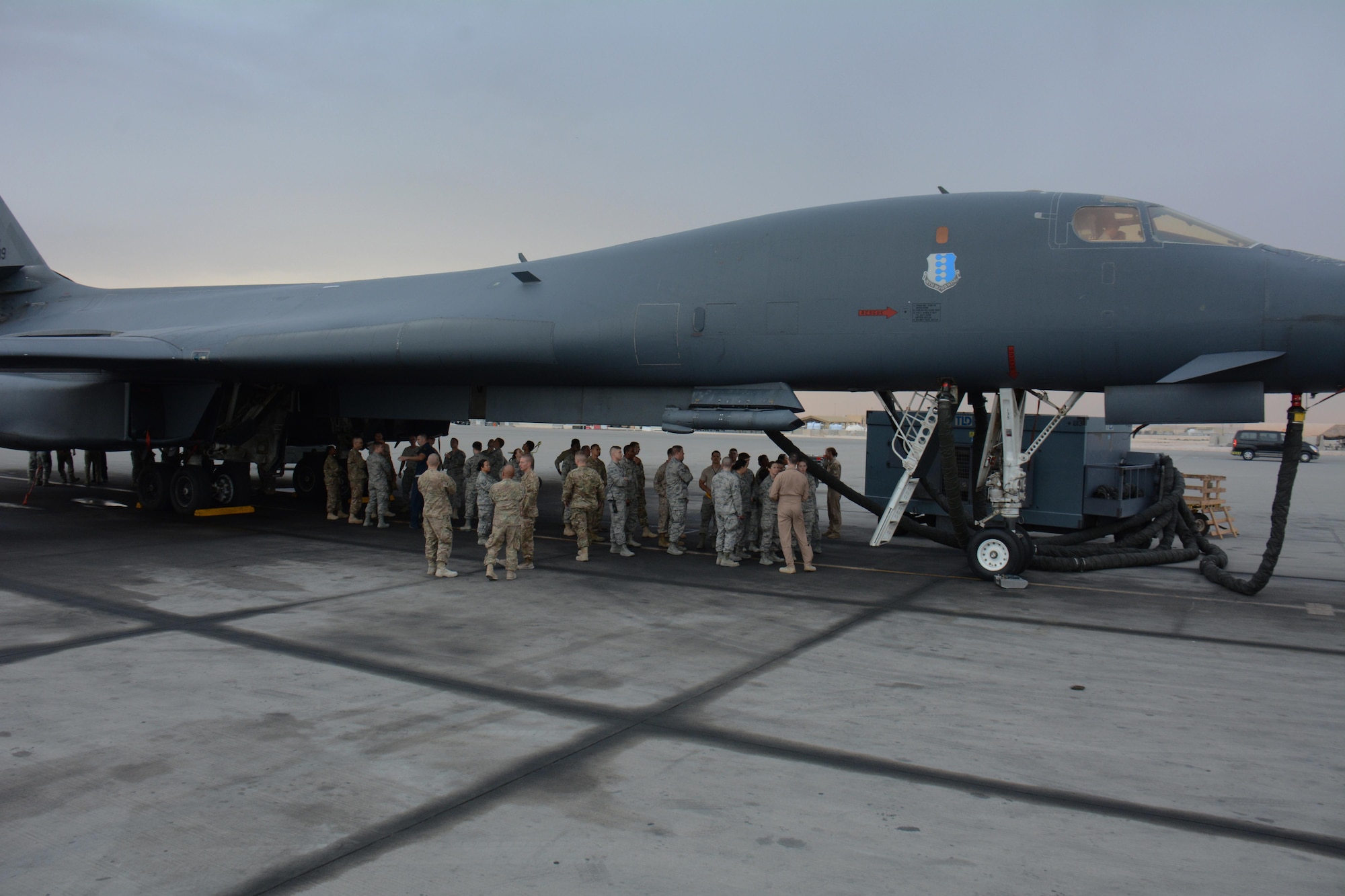Forty service members participate in a tour of the B-1 Lancer at Al Udeid Air Base, Qatar Nov. 24. The tour featured a presentation on the B-1's capabilities and videos showcasing strikes the bomber has carried out. Service members were selected for the tour by their unit leadership for outstanding performance. (U.S. Air Force photo by Tech. Sgt. James Hodgman/Released)