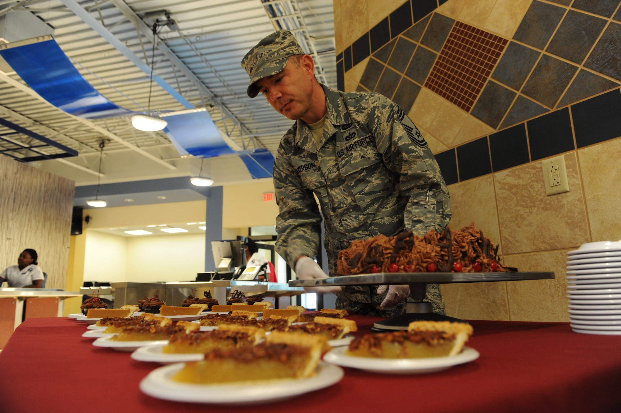 U.S. Air Force Chief Master Sgt. Jason Alverson, prepares to serve a variety of desserts at on Thanksgiving Day at the Georgia Pines Dining Facility, Nov. 26, 2015, at Moody Air Force Base, Ga. The Thanksgiving Day meal was an opportunity for Airmen and their families to enjoy a home cooked meal. (U.S. Air Force photo by Capt. Korey Fratini/Released)