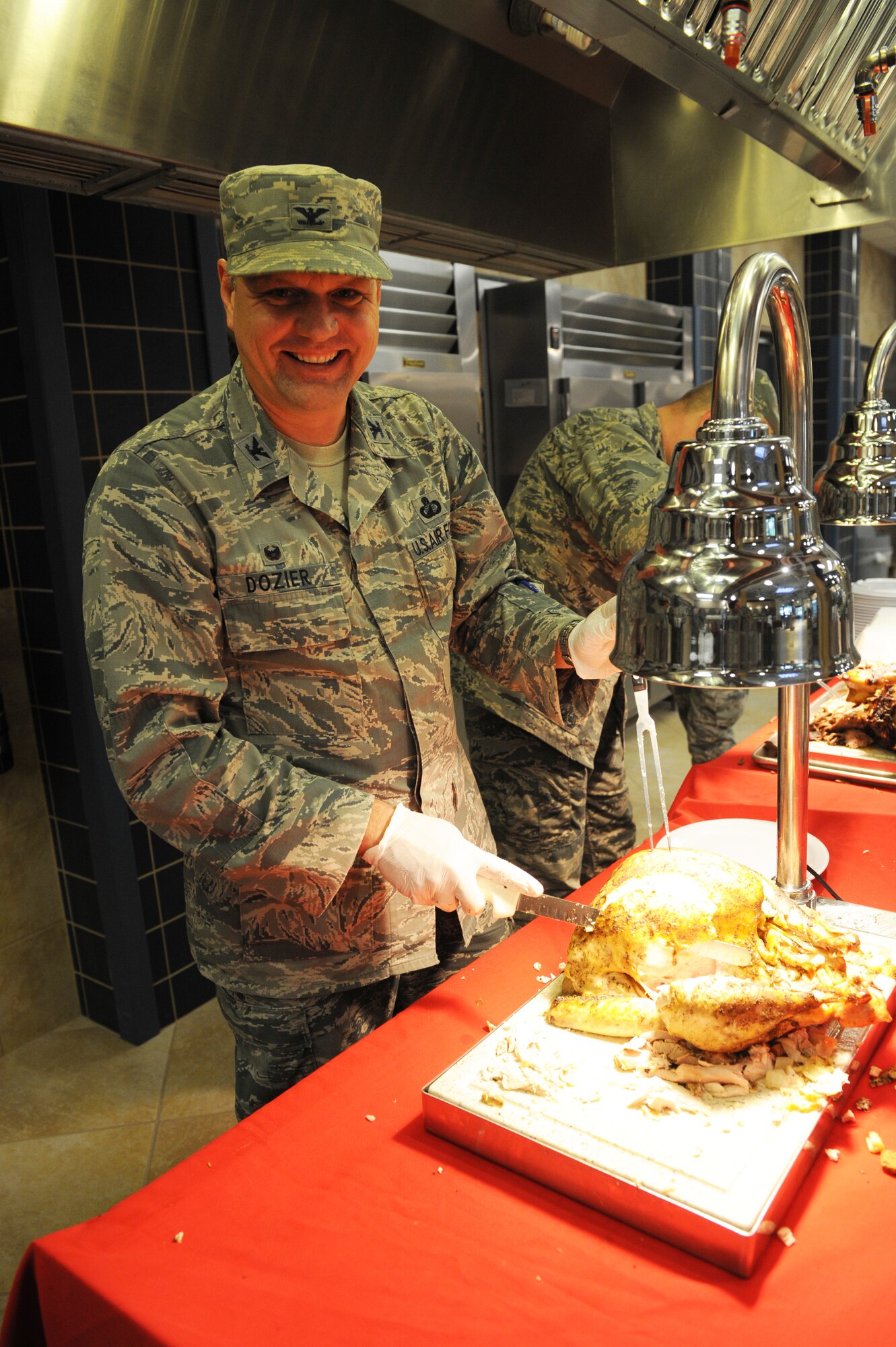 U.S. Air Force Col. Norman Dozier, 23d Mission Support Group command, carefully carves the turkey that was served on Thanksgiving Day at the Georgia Pines Dining Facility, Nov. 26, 2015, at Moody Air Force Base, Ga. Dozier was among many other volunteers from Team Moody who served Thanksgiving Day meals. (U.S. Air Force photo by Capt. Korey Fratini/Released)