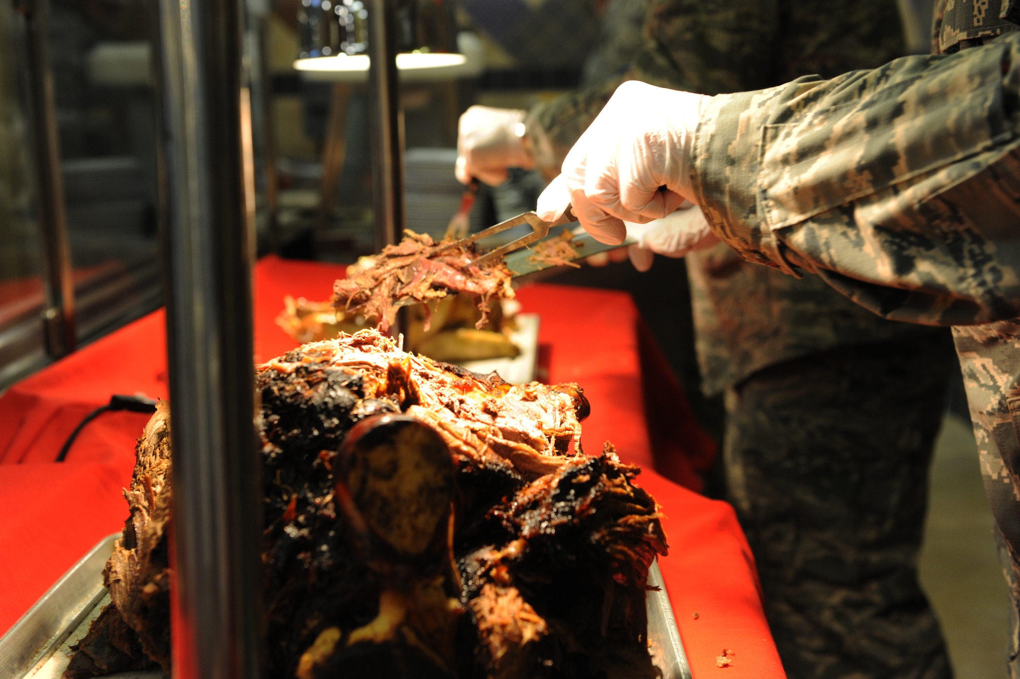 U.S. Air Force Col. Shane Barrett, 23d Maintenance Group commander, carves slices of roast beef on Thanksgiving Day at the Georgia Pines Dining Facility, Nov. 26, 2015, at Moody Air Force Base, Ga. The dining facility served Thanksgiving meals to Airmen, retirees and their dependents. (U.S. Air Force photo by Capt. Korey Fratini/Released)