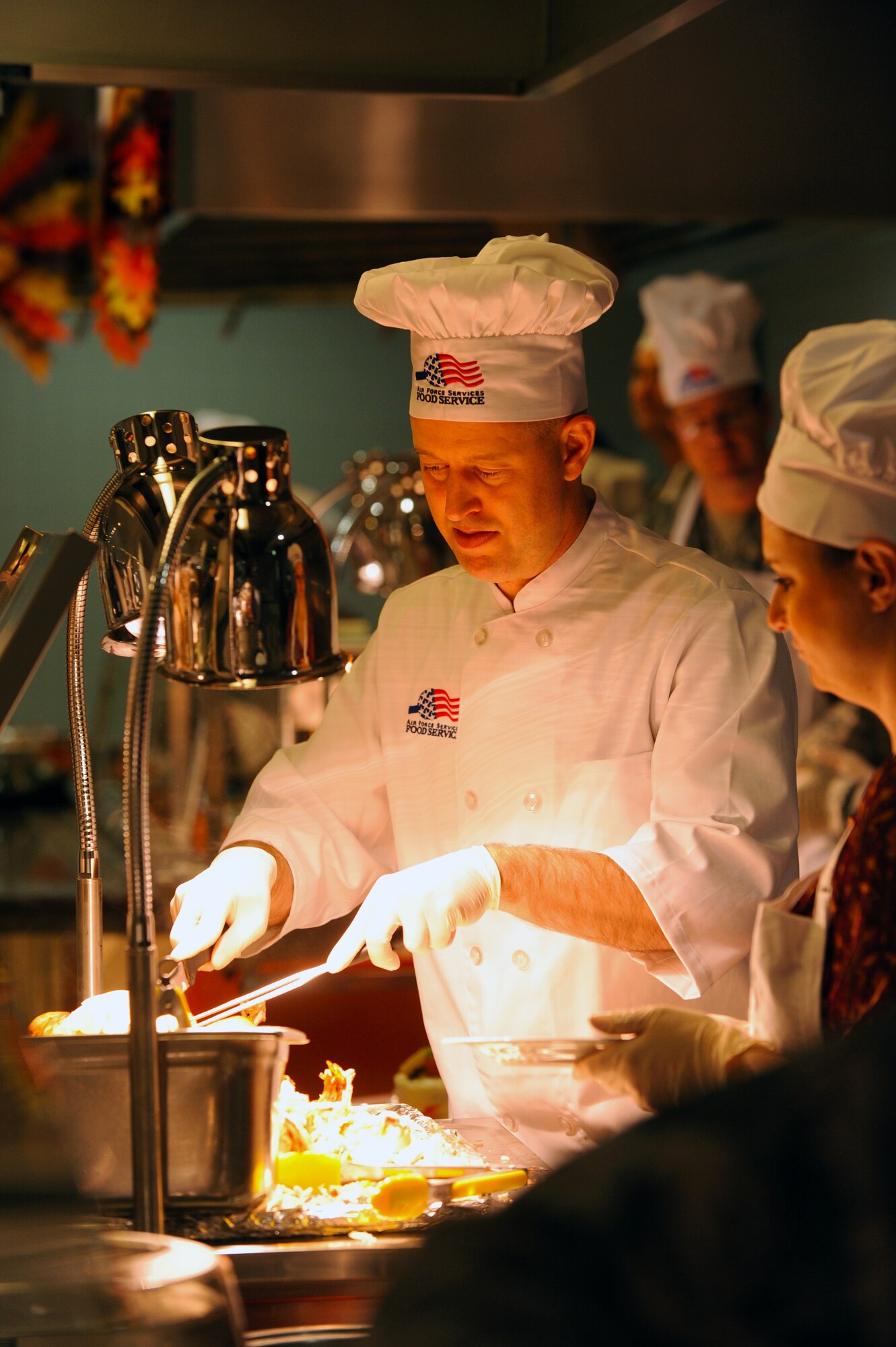 Col. Brandon Hileman, 86th Airlift Wing vice commander, serves food during a Thanksgiving meal Nov. 26, 2015, at Ramstein Air Base, Germany.  The event aims to boost morale and provide senior leaders, retirees, service members and their families an opportunity to spend some time together during the holiday. Menu items included turkey, prime rib, ham, mashed potatoes and dressing. (U.S. Air Force photo/Staff Sgt. Sharida Jackson)