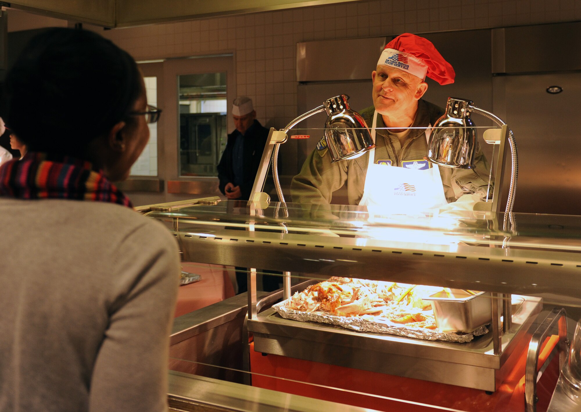Gen. Frank Gorenc, U.S. Air Forces in Europe and Air Forces Africa commander, serves meals at the Rheinland Inn Dining Facility Nov. 26, 2015, at Ramstein Air Base, Germany. Leaders gathered to serve holiday meals to Airmen and their families and to wish everyone a safe and happy holiday. (U.S. Air Force photo/Staff Sgt. Sharida Jackson)