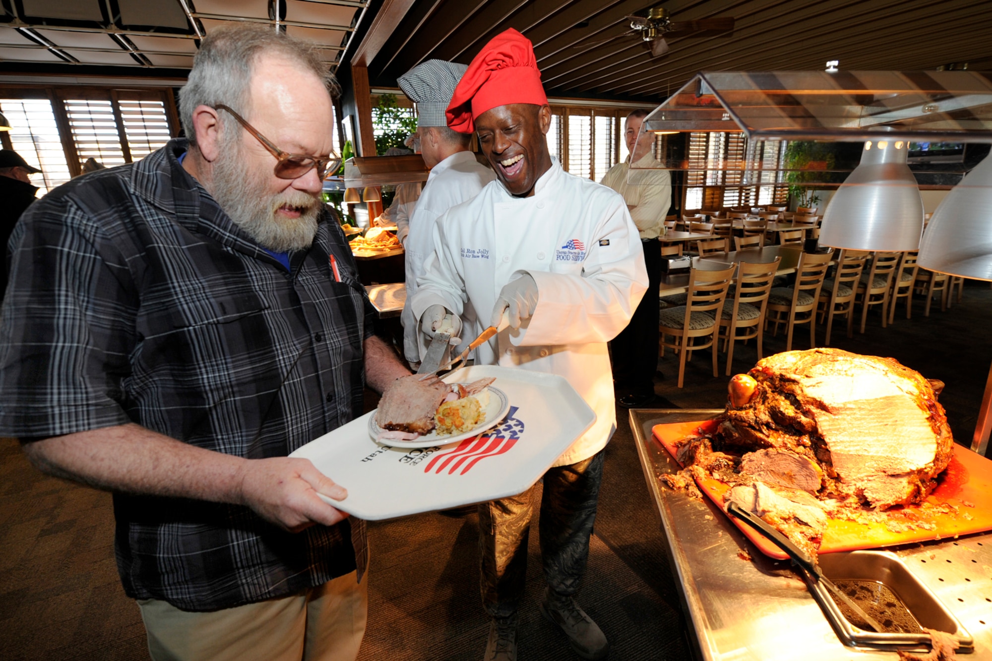 Col. Ron Jolly, 75th Air Base Wing commander, serves a guest Nov. 26 at the Hillcrest Dining Facility, Hill Air Force Base. Hundreds of Airmen, family members and retirees enjoyed the annual Thanksgiving meal. (U.S, Air Force photo by Paul Holcomb)