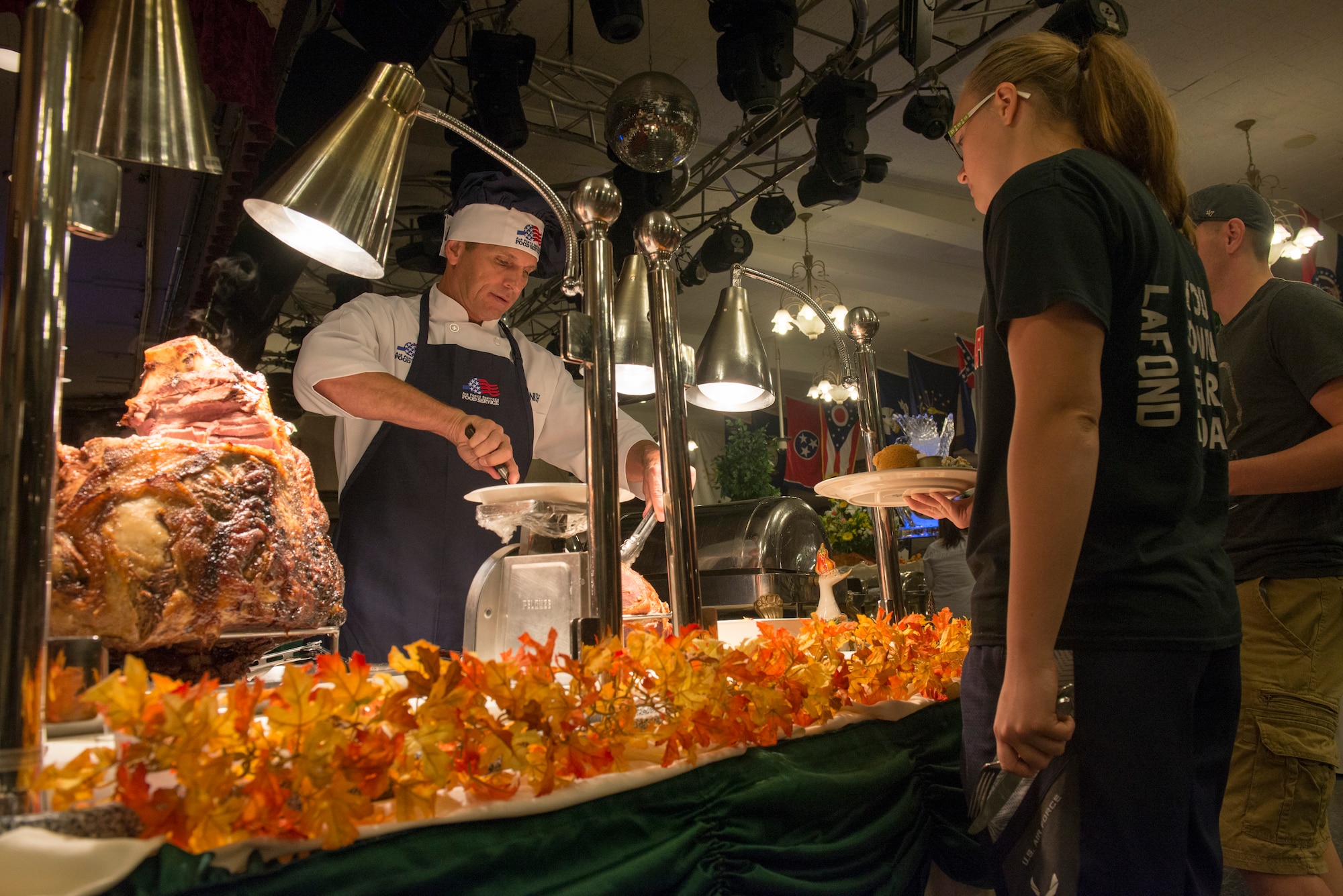 Brig. Gen. Barry Cornish, 18th Wing commander, serves Thanksgiving meals to service members and their families Nov. 26, 2015, at the Rocker NCO Club at Kadena Air Base, Japan. Cornish, along with the rest of Kadena's leadership, served various Thanksgiving dishes to more than 100 Airmen and their families during the holiday. (U.S. Air Force photo by Senior Airman Omari Bernard)