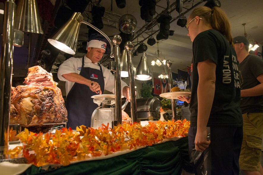 Brig. Gen. Barry Cornish, 18th Wing commander, serves Thanksgiving meals to service members and their families Nov. 26, 2015, at the Rocker NCO Club at Kadena Air Base, Japan. Cornish, along with the rest of Kadena's leadership, served various Thanksgiving dishes to more than 100 Airmen and their families during the holiday. (U.S. Air Force photo by Senior Airman Omari Bernard)