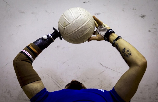 Retired Staff Sgt. Daniel Crane tosses a volleyball while conducting ab exercises during the Air Force-hosted Northeast Regional Warrior Care event at Joint Base Andrews, Md., Nov. 17, 2015. The Air Force Wounded Warrior Program is a federally mandated program that provides personalized care, services and advocacy for wounded, ill and injured service members. Air Force Warrior Care support programs focus on specific personal and family needs through individualized support. (U.S. Air Force photo/Staff Sgt. Marianique Santos)